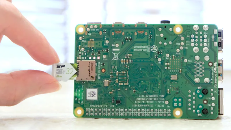 Raspberry Pi 4 Model B with a microSD card, used to control console TVs from iCafeCloud
